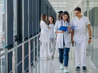 team-young-specialist-doctors-standing-corridor-hospital